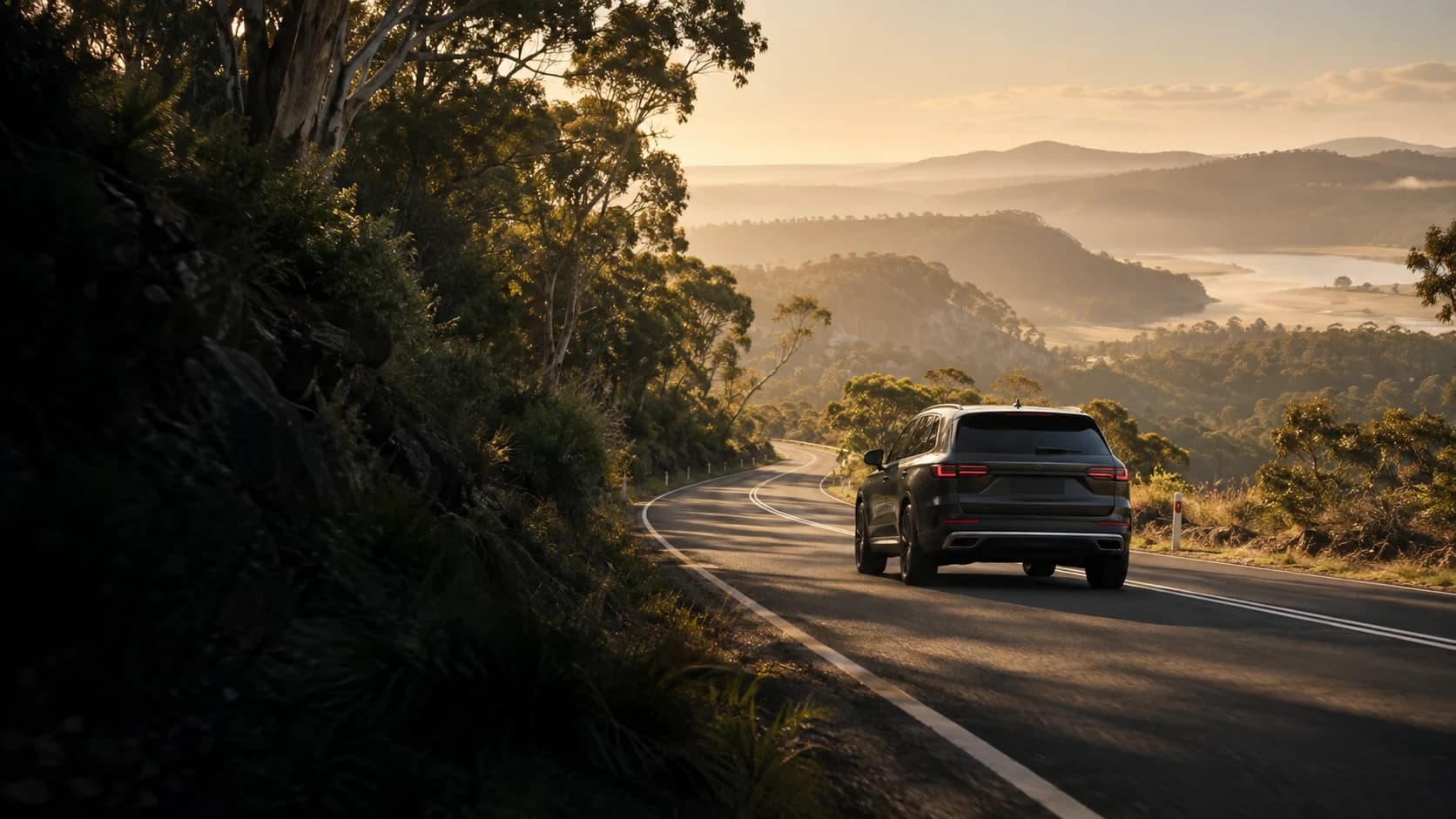 Illustrative dark vehicle on a scenic Australian road through eucalyptus hills